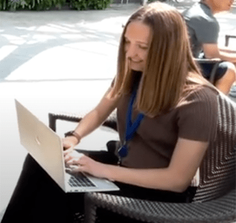 梅根·Baudendistel sitting outside with laptop