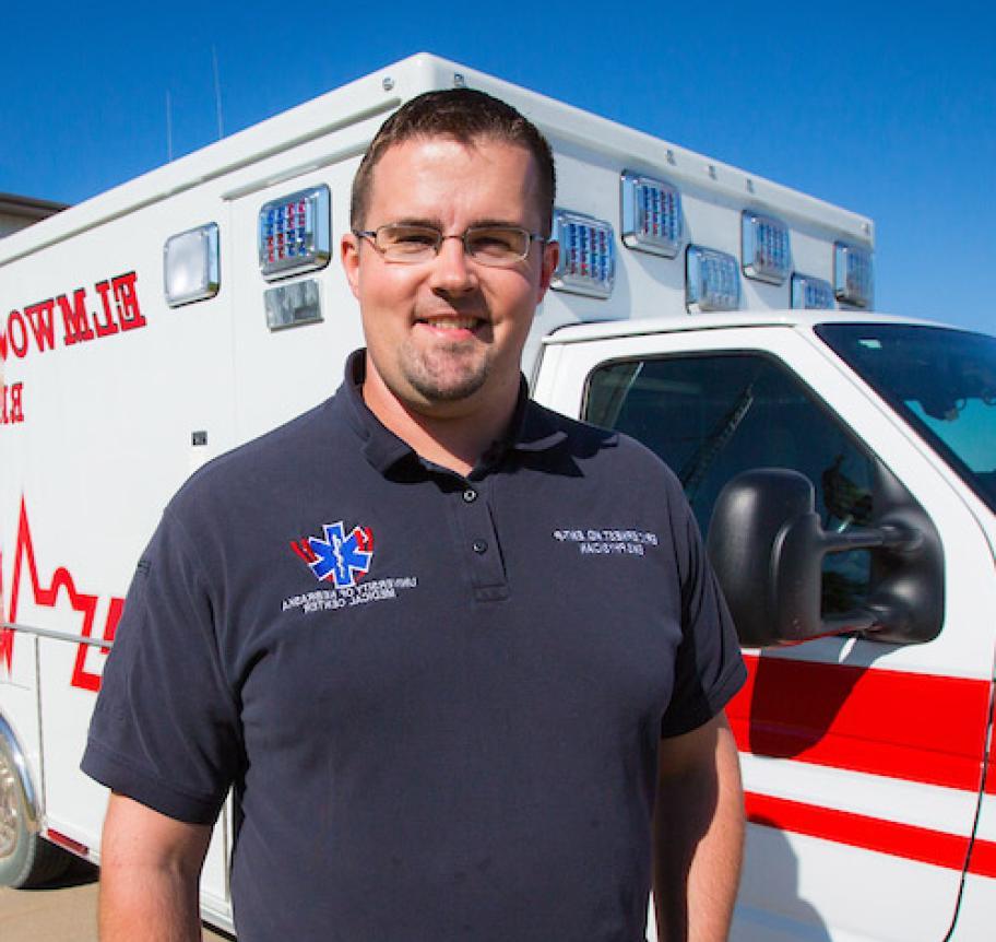 A man standing in front of an ambulance